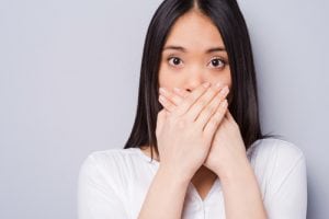 img-blog-Surprised young Asian woman covering mouth with hands
