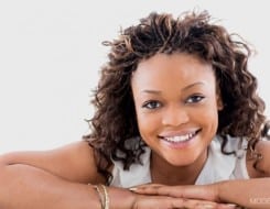 Adult woman happily leaning over on surface