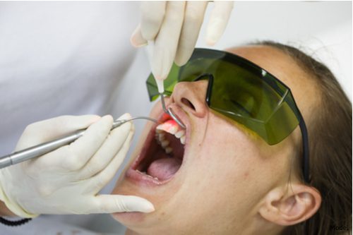 Patient undergoing dental treatment to improve oral health.