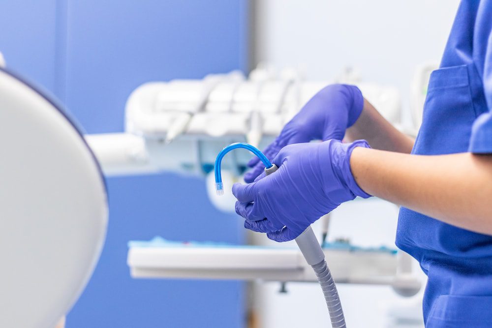 A dental hygienist holding a medical tool that can be used to deliver highly oxygenated water